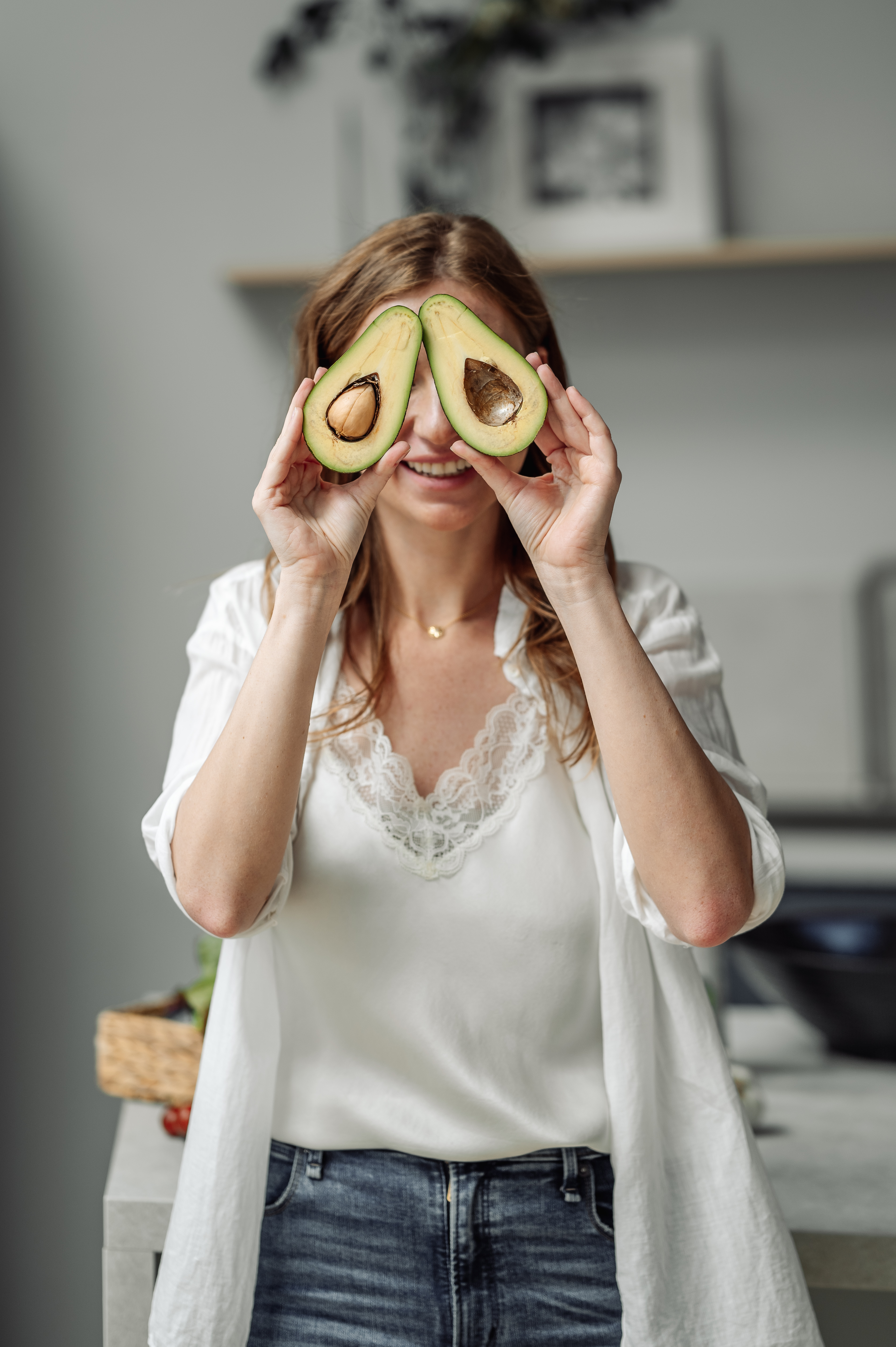 A woman in a sunlit Spanish kitchen, pouring oil over a plate already set